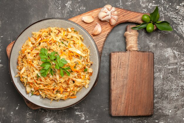 Bovenaanzicht kool schotel van kool knoflook citrusvruchten op het houten bord van de close-up