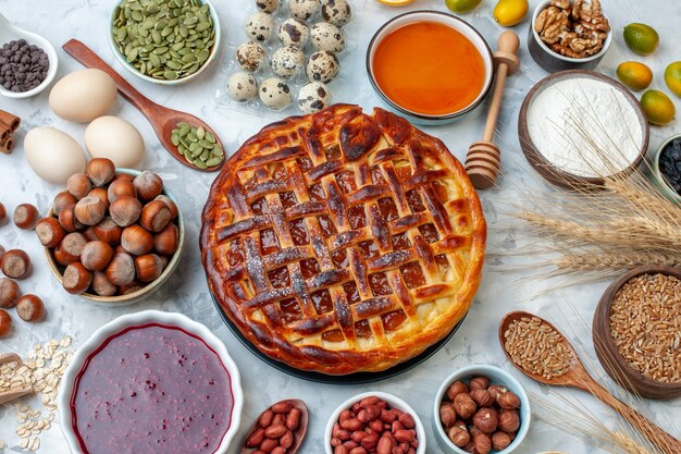 Bovenaanzicht lekkere fruitige taart met noten en eieren op licht bakken biscuit taart dessert kleur thee cake cookie bakkerij broodje