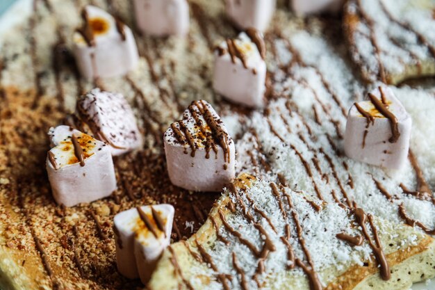 Bovenaanzicht pannenkoeken met marshmallow en chocolade glazuur met kokosvlokken