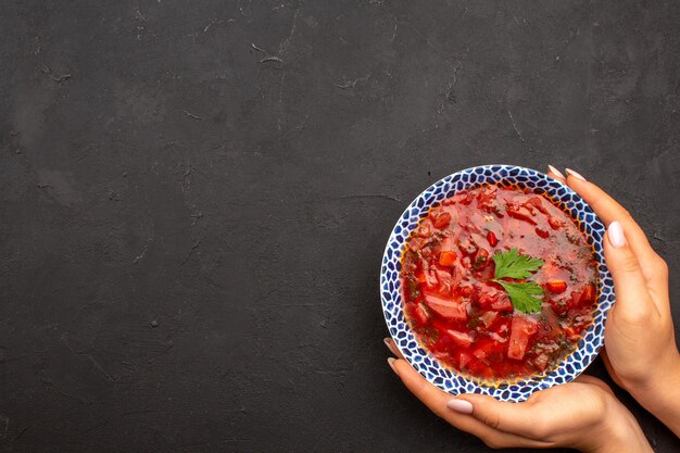 Bovenaanzicht smakelijke borsch beroemde Oekraïense bietensoep op donkere ruimte