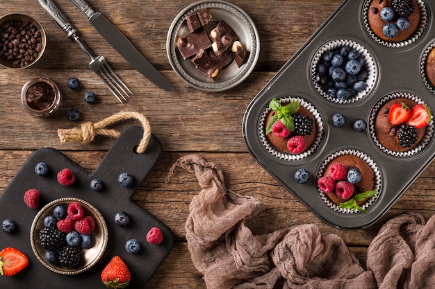 Bovenaanzicht smakelijke muffin met bosvruchten in bakplaat