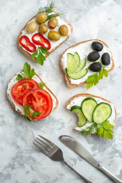 Bovenaanzicht smakelijke sandwiches met komkommers en olijven op witte achtergrond hamburger toast lunch horizontale voedsel broodmaaltijd