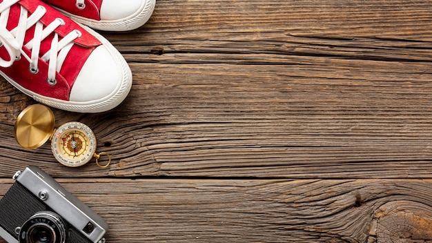 Bovenaanzicht sneakers en kompas op een tafel