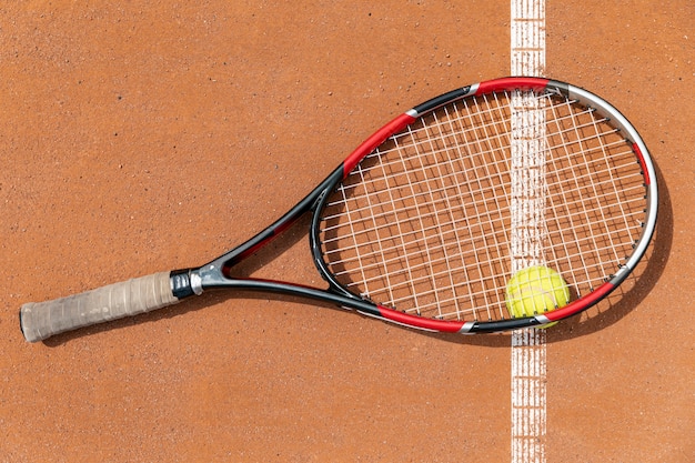 Gratis foto bovenaanzicht tennisracket over bal