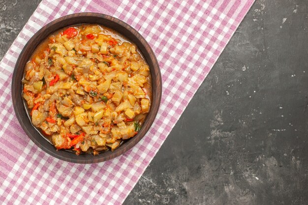 Bovenaanzicht van geroosterde auberginesalade in kom op donkere ondergrond