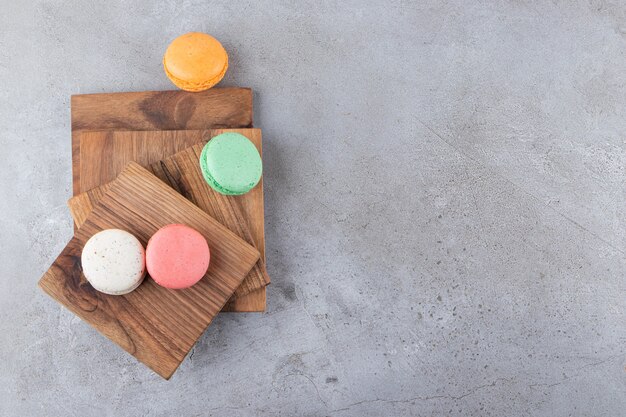 Bovenaanzicht van kleurrijke koekjes op een houten bord.