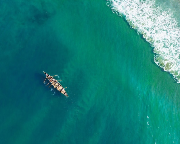 Bovenaanzicht van mensen in een boot die vissen in Varkala Beach