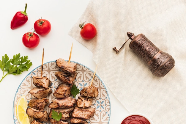 Bovenaanzicht van plaat met heerlijke kebab en kruiderijmolen