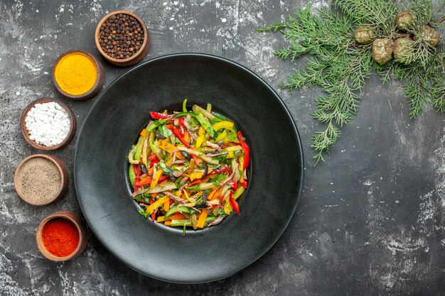 Bovenaanzicht van smakelijke groentesalade op donkere ondergrond