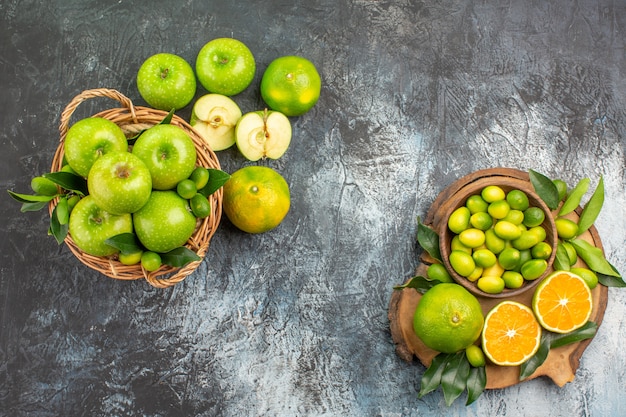 Bovenaanzicht van verre appels het bord met citrusvruchten mand met appels