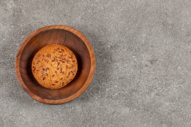 Bovenaanzicht van vers gebakken zelfgemaakt koekje in houten kom.