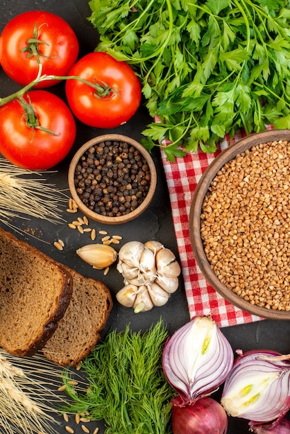 Bovenaanzicht van verse groenten boekweit in een bruine kom sneetjes brood spikes groen