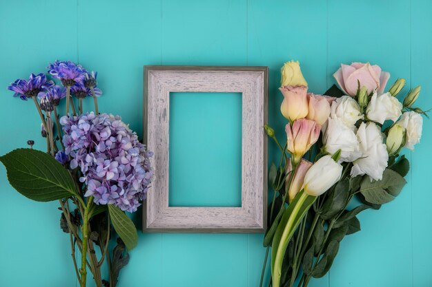 Bovenaanzicht van verse prachtige bloemen zoals roze tulp daisy op een blauwe achtergrond met kopie ruimte