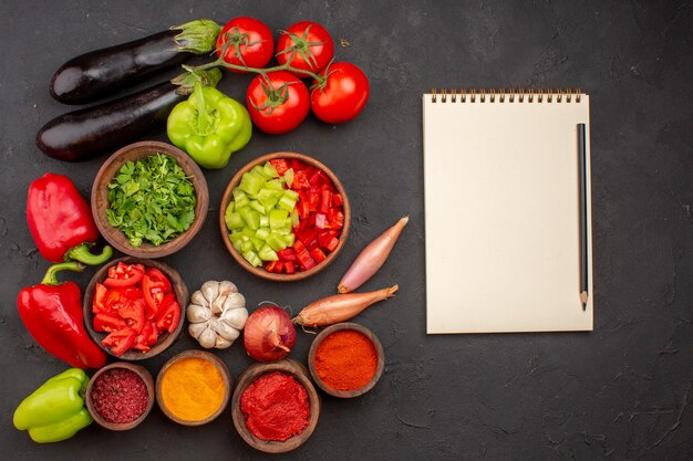 Bovenaanzicht verse groenten met greens en verschillende kruiden op grijze achtergrond maaltijdsalade gezondheidsvoedsel groenten