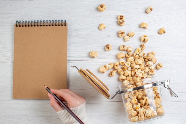 Bovenaanzicht zoete popcorn op lichte ondergrond