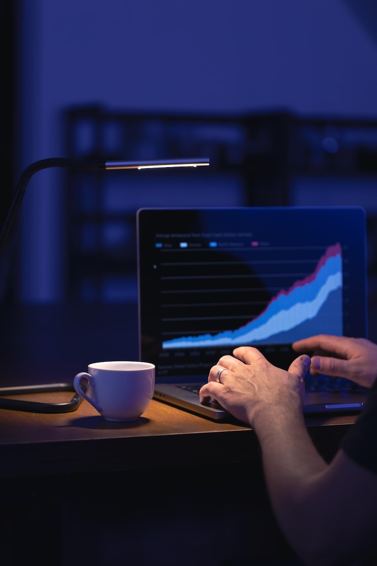 Gratis Foto broker kijkt naar laptop analyseert aandelenmarkt investeren handel aandelen grafiek