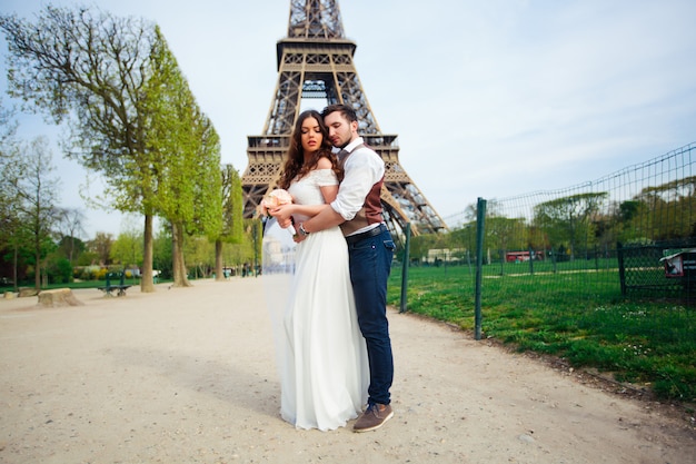 Bruid en bruidegom die een romantisch ogenblik op hun huwelijksdag in parijs hebben