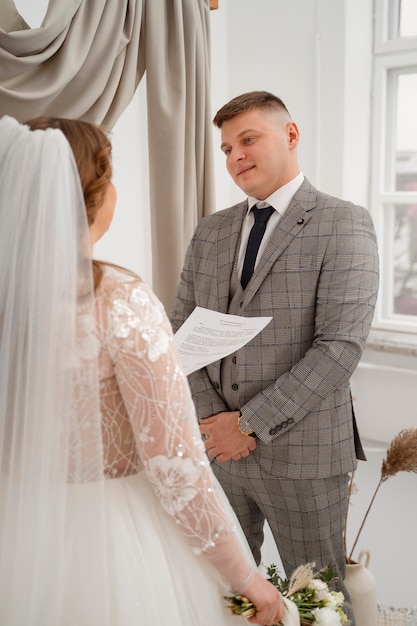 Gratis foto bruid en bruidegom wisselen geloften uit tijdens de huwelijksceremonie