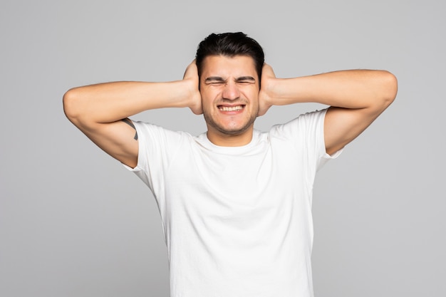 Casual man coning zijn oren en schreeuwen geïsoleerd op een witte