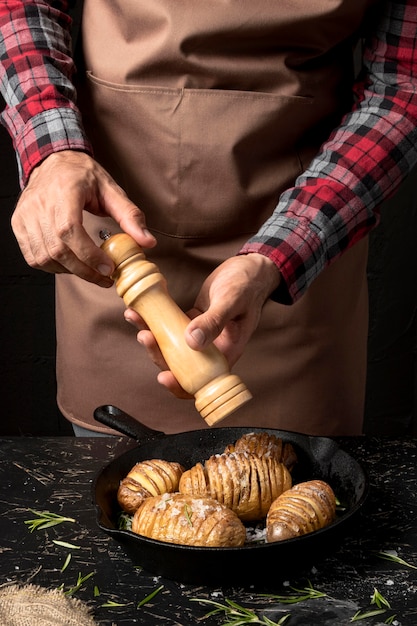 Chef-kok kruiden aardappelen in de pan