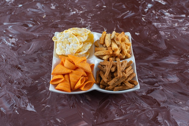 Chips met paneermeel in een kom, op de marmeren tafel.