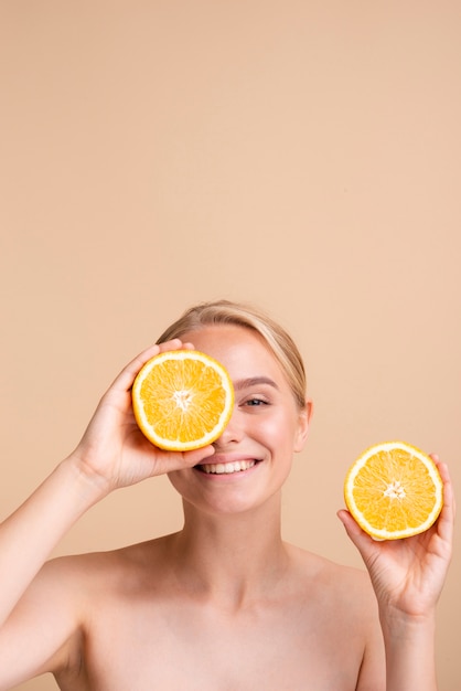 Close-up blondemeisje met citrusvrucht en exemplaar-ruimte