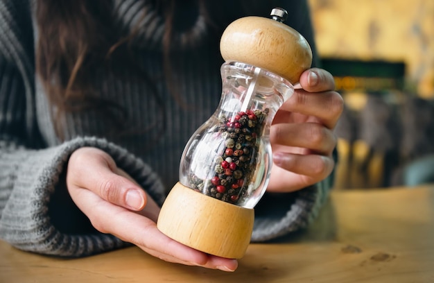 Close-up fles peper in containers met molen