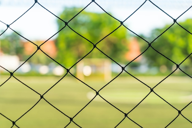 Gratis foto close-up netto met voetbalveld achtergrond