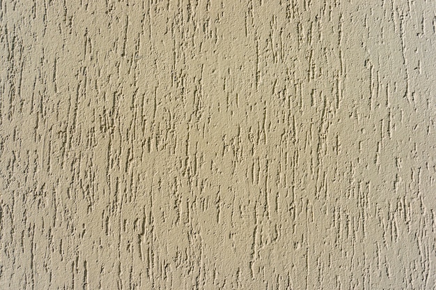 Close-up shot van een beige getextureerde muur