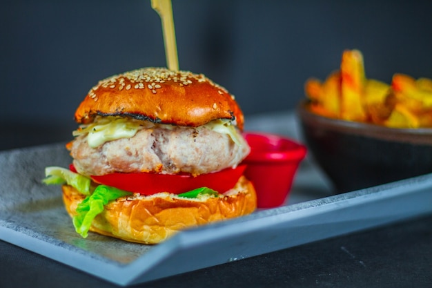 Close-up shot van een heerlijke cheeseburger met verse ingrediënten bevestigd met spiesjes stick