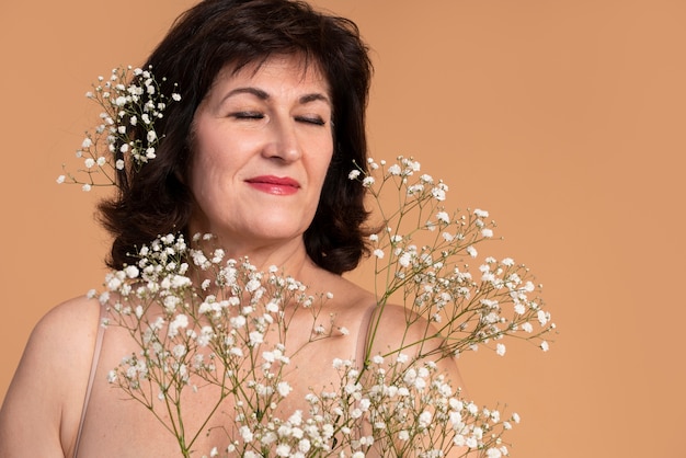 Close-up smiley vrouw met bloemen