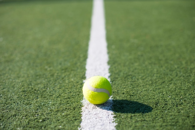 Close-up tennisbal op een lijn van een tennisbaan