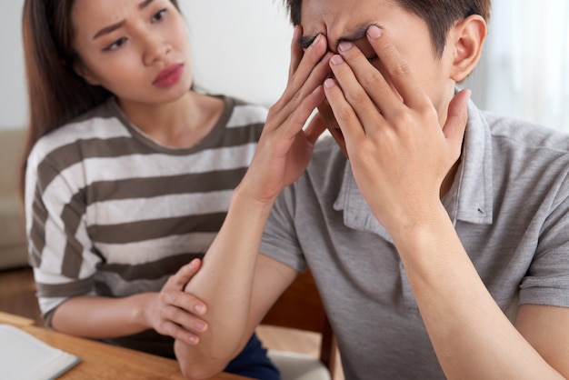 Close-up van de mens die financiële uitdagingen onder ogen zien die door zijn vrouw worden getroost