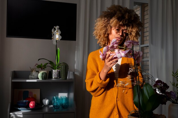 Close-up van de vrouw die haar huis versiert met orchideeën