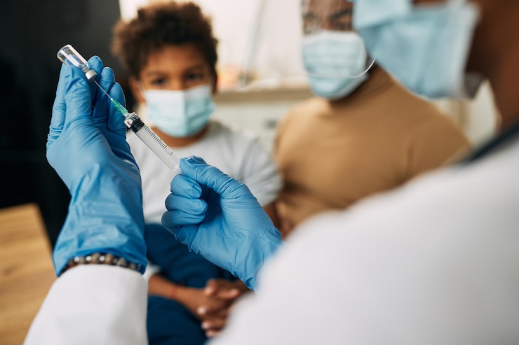 Gratis Foto close-up van een kinderarts die een vaccin voorbereidt voor een kind