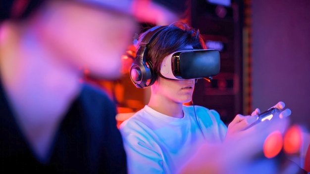 Close-up van een tiener die een gameconsole speelt in VR-headset en hoofdtelefoon met gamepad