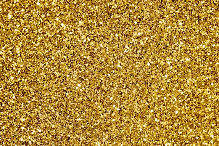 Gratis Foto close-up van gouden glitter textureerde achtergrond