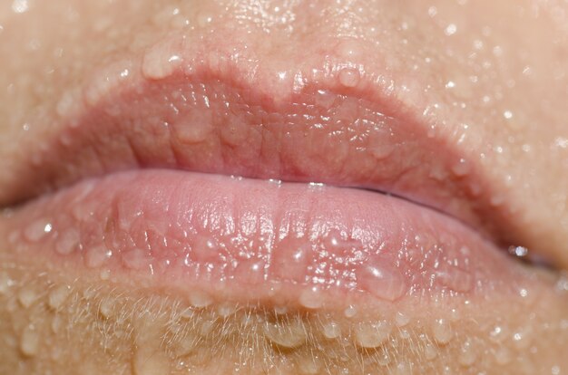 Close-up van natte lippen onder de lichten - hygiëneconcept