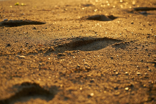 Close-up van zandstrand met voetafdrukken