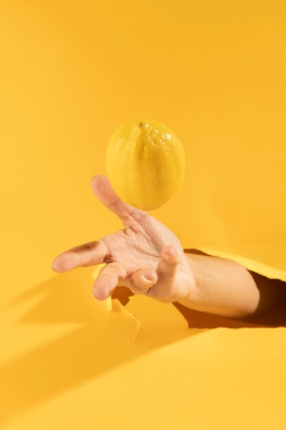 Close-uphand die ruwe citroen vangen