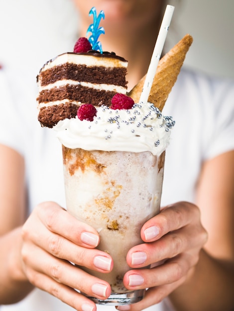 Gratis foto close-upmening die van vrouw heerlijke milkshake houden