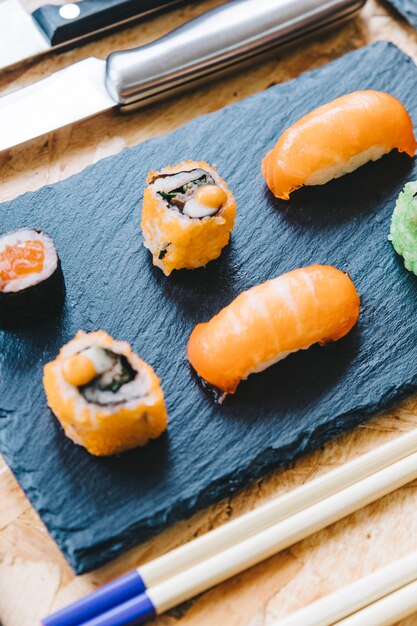 Close-upsushi dichtbij eetstokjes en mes