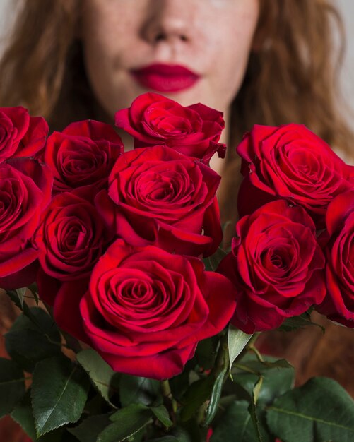 Close-upvrouw die een boeket van rozen houden