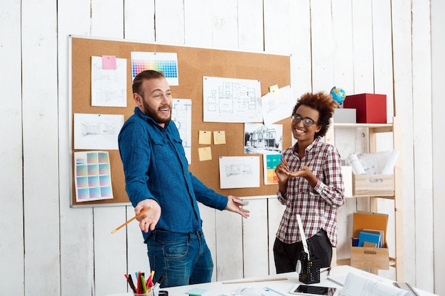 Collega's glimlachen, spreken en bespreken nieuwe ideeën