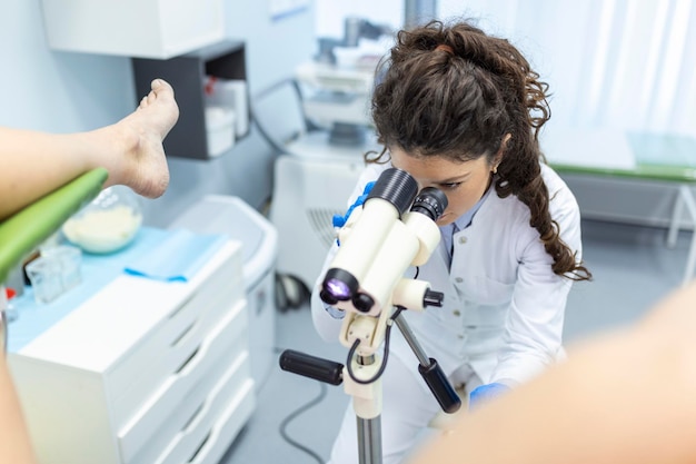 Colposcope close-up beeld van een gynaecoloog en een patiënt in een gynaecologische stoel vrouwenconsult