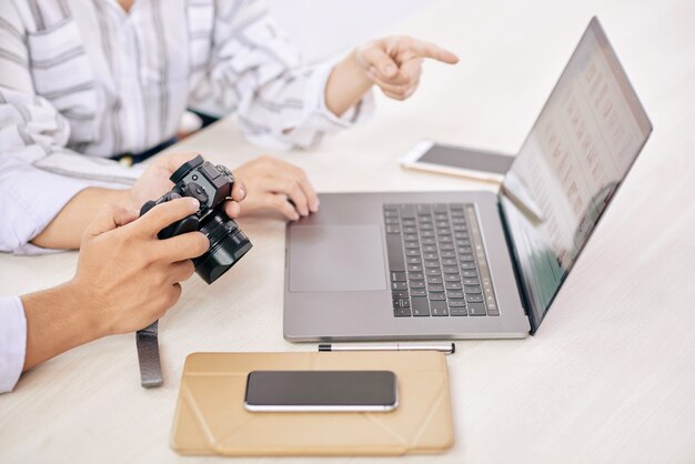 Coworkingfotografen met gadget bij bureau