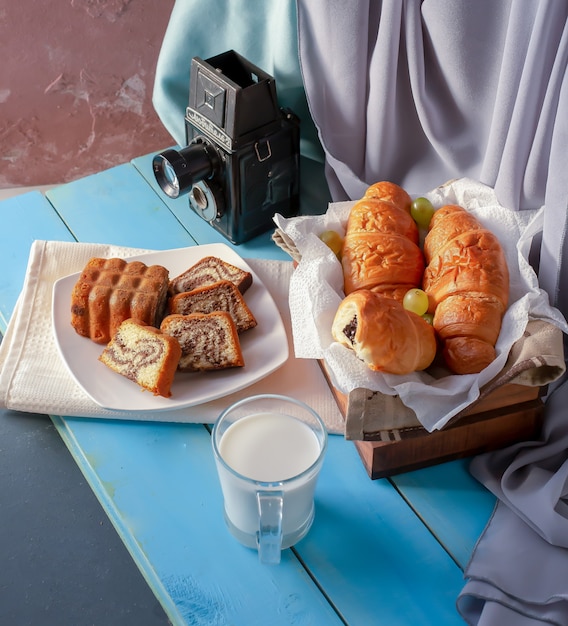 Croissants en vanille taart op de tafel met een glas melk.