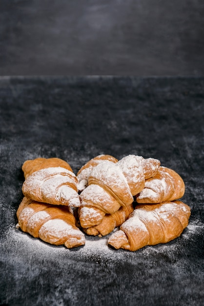croissants met poedersuiker op grijze tafel.