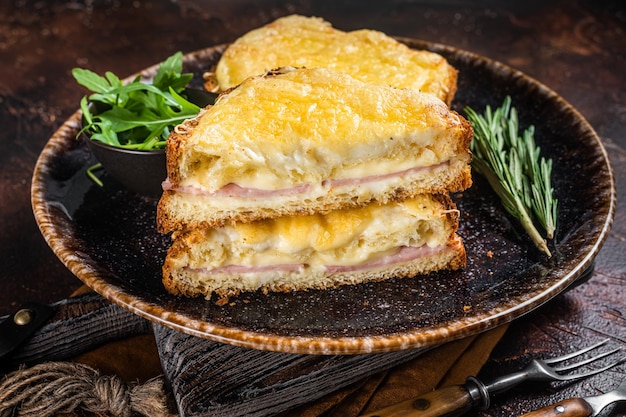 Croque monsieur tosti met kaas, ham, gruyère en bechamelsaus. donkere achtergrond. bovenaanzicht.