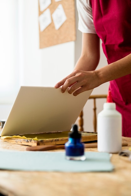 De hand die van de vrouw pulp plaatst voor het maken van document